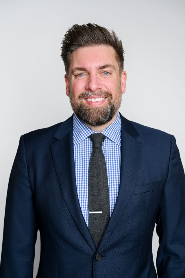 William Ryan Hunt, computer scientist and growth marketer, smiling in a navy suit